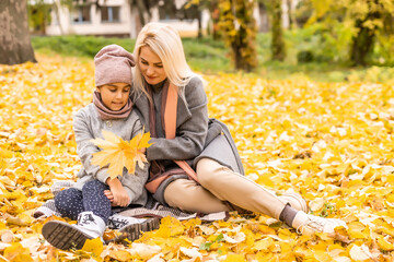 Wall Mural - Mother and daughter in autumn yellow park.