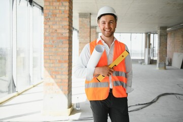 Wall Mural - Business architect man wearing hardhat standing of a building project