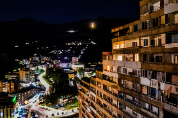 Night city from a bird's eye view. The light of houses and cars. A beautiful city with rivers, bridges and beautiful buildings. City among the mountains, Kapan, Armenia