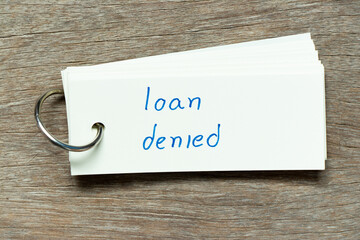 Wall Mural - Flash card with handwriting word loan denied on wood background