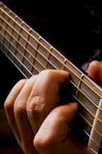 Close Up Of A Muscian Hands Playing A Classic Acoustic Guitar