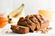 Homemade gluten free banana bread with walnuts cut into slices, closeup view