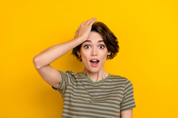 Closeup photo of young funny grimace girl touching head forgot turn off computer home isolated on yelow color background