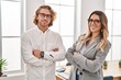 © Krakenimages.com - Man and woman business workers standing with arms crossed gesture at office