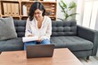© Krakenimages.com - Young latin woman having psychology session using laptop at psychology center