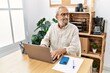© Krakenimages.com - Senior grey-haired man smiling confident working at office