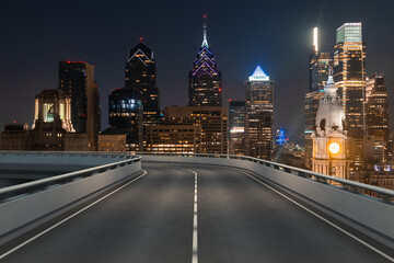 Empty urban asphalt road exterior with city buildings background. New modern highway concrete construction. Concept way to success. Transportation logistic industry fast delivery. Philadelphia. USA.