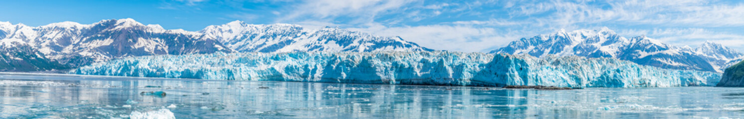  A panorama view past floating ice in Disenchartment Bay towards in the Hubbard Glacier, Alaska in summertime