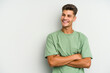 © Asier - Young caucasian man isolated on white background smiling confident with crossed arms.