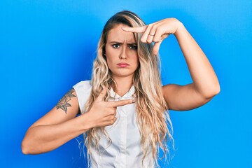 Sticker - Beautiful young blonde woman doing picture frame gesture with hands skeptic and nervous, frowning upset because of problem. negative person.