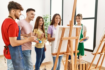 Sticker - Group of people smiling happy drawing on canvas standing at art studio.