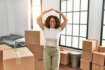 Sticker - Middle age hispanic woman smiling confident doing house gesture at new home