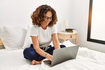 Sticker - Middle age hispanic woman smiling confident using laptop at bedroom