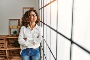 Sticker - Middle age hispanic woman smiling confident with arms crossed gesture at office