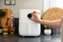 Woman Cooking With Modern Air Fryer