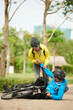 © DragonImages - Woman helping to get up boyfriend who fell off bicycle
