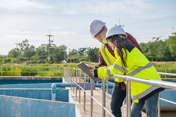 Environmental engineers work at wastewater treatment plants,Water supply engineering working at Water recycling plant for reuse,Technicians and engineers discuss work together.