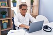© Krakenimages.com - Middle age man sitting on wheelchair teleworking at home