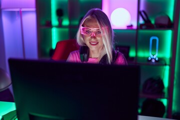 Sticker - Young blonde woman streamer using computer and virtual reality glasses at gaming room