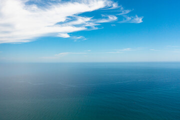 Aerial view of Blue sea with waves and sky with clouds. Ocean skyline.