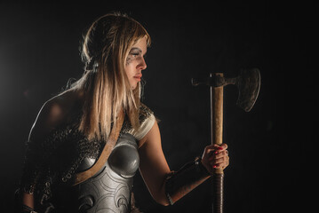 Beautiful woman warrior with the axe concept.