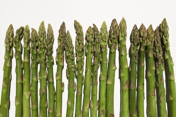 Wall Mural - Fresh green asparagus on white background. Fresh green asparagus on white background