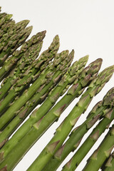 Wall Mural - Fresh green asparagus on white background. Fresh green asparagus on white background