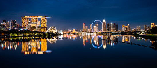 Wall Mural - Singapore city skyline with modern skyscraper architecture building for concept of financial business and travel in Asia cityscape urban landmark, marina bay at night district dusk sky