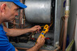 © spatesphoto - Professional Hvac Technician Checking Current on Motor Wire