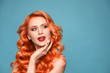 Beautiful Woman With Long Orange Hair On Light Blue Background