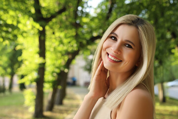 Wall Mural - Portrait of beautiful woman outdoors on sunny day, space for text