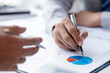 © kamiphotos - Two businessmen pointed to the material for the meeting, working together to plan to develop and solve common business problems. Concept of business management for growth and quality.