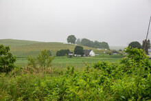 Amish Homestead In The Lush Green Countryside Of Holmes County Ohio In The Fog