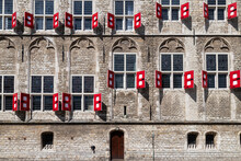 Side Facade With Windows And Red Shutters Of The Old Town Hall In The Medieval City Of Gouda.