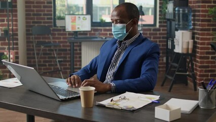Poster - Project specialist working with company statistics on presentation in office during pandemic. Startup employee planning business strategy with website report, browsing internet on laptop.