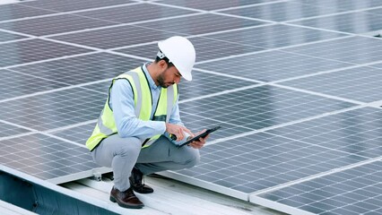 Aufkleber - Young engineer or contractor inspecting solar panels on a roof in the city. One confident young manager or maintenance worker smiling while installing power generation equipment and holding a tablet