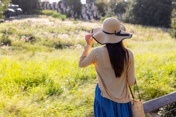 Wall Mural - Travel woman look at the greenery view under sunset