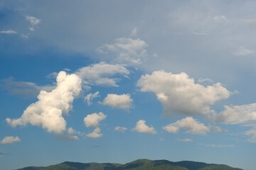 Wall Mural - The white clouds have a strange shape and moutain.The sky and the open space have mountains below.