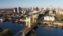 Descending Close-up Aerial Shot Of Tower Bridge On The Sacramento River With Downtown Sacramento In The Background. 4K