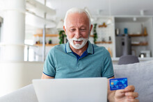 Mature Man Using Laptop, Holding Plastic Credit Or Debit Card, Senior Grey Haired Customer Making Secure Internet Payment, Shopping Or Browsing Online Banking Service, Entering Information