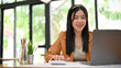 © bongkarn - Beautiful Asian female accountant or financial worker working on her financial task on laptop.