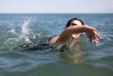 Fototapeta Łazienka - Happy pregnant woman on sea vacation. Future happy mother bathes in warm sea water