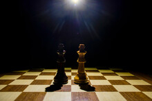 The Two Kings Facing Each Other In A Game Of Chess. The Chessboard Is Isolated On A Black Background.