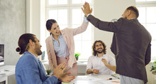 Group Of Happy People Making Deal And Giving Each Other High Five. Successful Businessman And Businesswoman Greeting Each Other In Informal Casual Business Meeting In Modern Office. Teamwork Concept