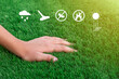 Close-up of a hand on a soft green artificial turf. Antibacterial, washable, fire retardant, breathable and UV resistant grass