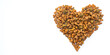 Valentines day and love of pets concept. Heart shaped cat dry kibble food on white background
