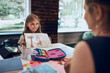 © Przemek Klos - Girl presenting her artwork teacher. Woman assisting schoolgirl during classes at primary school. Child drawing picture sitting at desk in classroom. Learning at primary school. Back to school