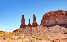 The Three Sisters Formation In Monument Valley On Arizona - Utah Border, Delicate And Interesting Sandstone Forms Created By Erosion, Part Of Holy Lands For Native Americans And Their Stories