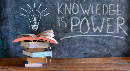 knowledge is power, books and blackboard with drawing of a lightbulb,education,learning,reading,idea,back to school concept.