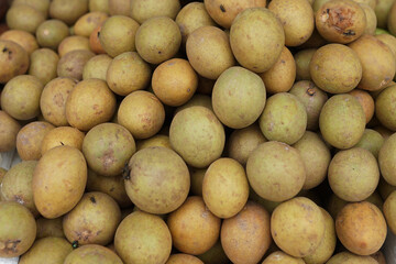 healthy and fresh sapodilla fruit neatly arranged for sale in the market. healthy and fresh fruit background